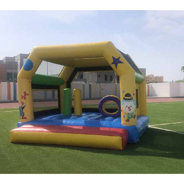 Yellow and blue bouncy castle on artificial grass