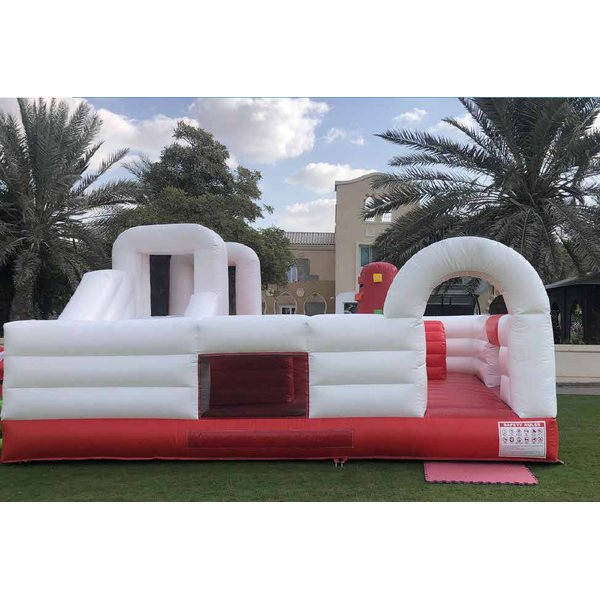 White and red inflatable obstacle course with a slide