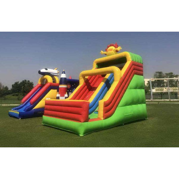 Tall red, yellow and green 6 m inflatable slide on a lawn