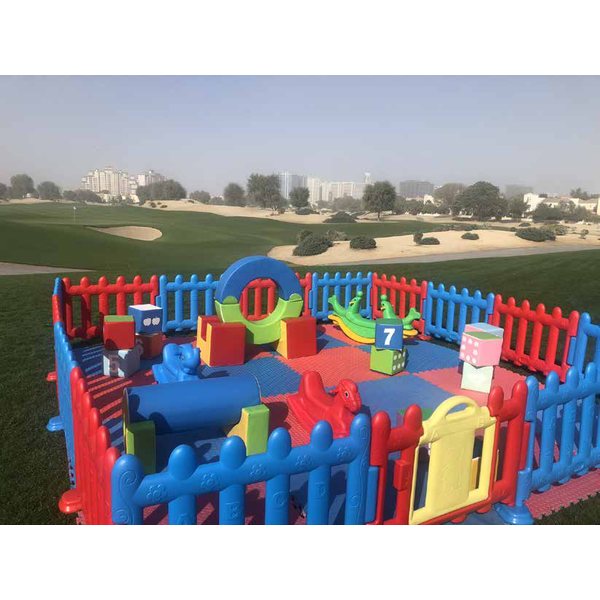 Fenced soft play area with foam blocks and soft games