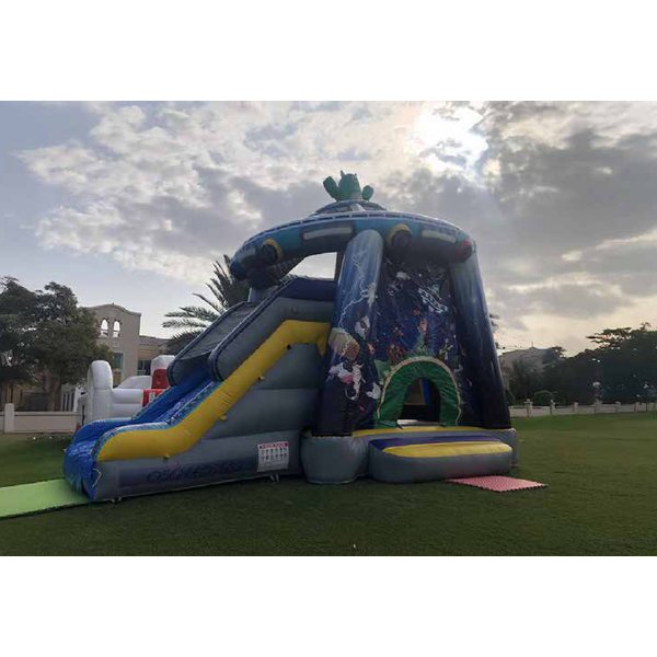 UFO-themed bouncy castle with a slide on a lawn